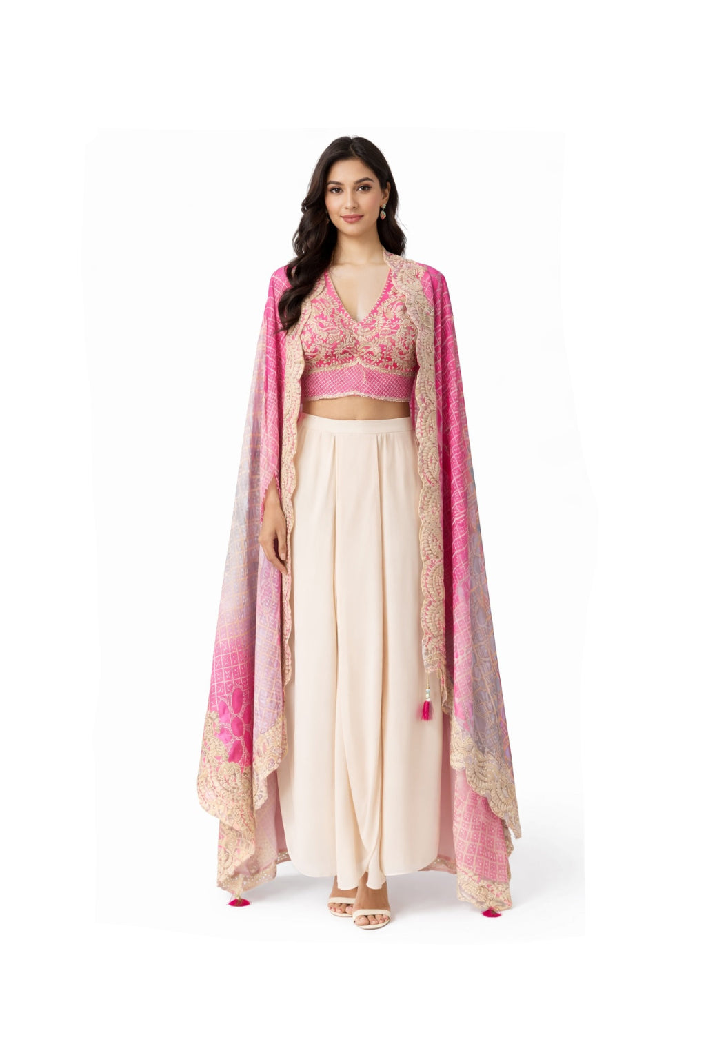 Woman wearing a traditional outfit with a pink blouse and beige skirt on a white background