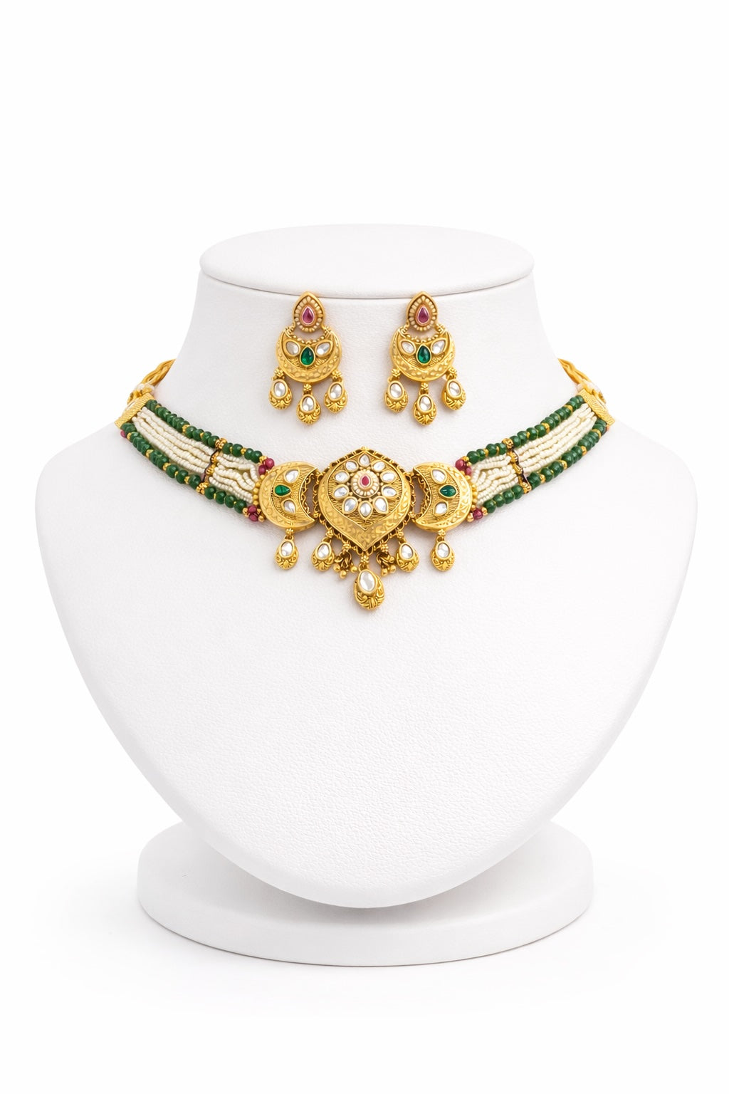 Gold necklace and earrings set on a white mannequin bust with a white background