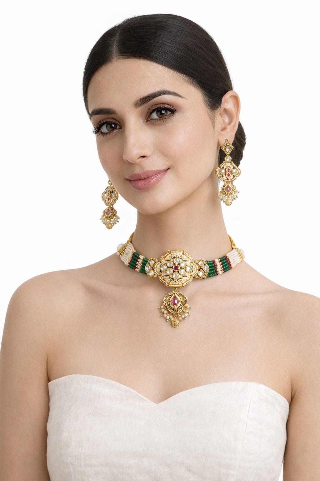 Woman wearing a gold and green necklace with matching earrings on a white background