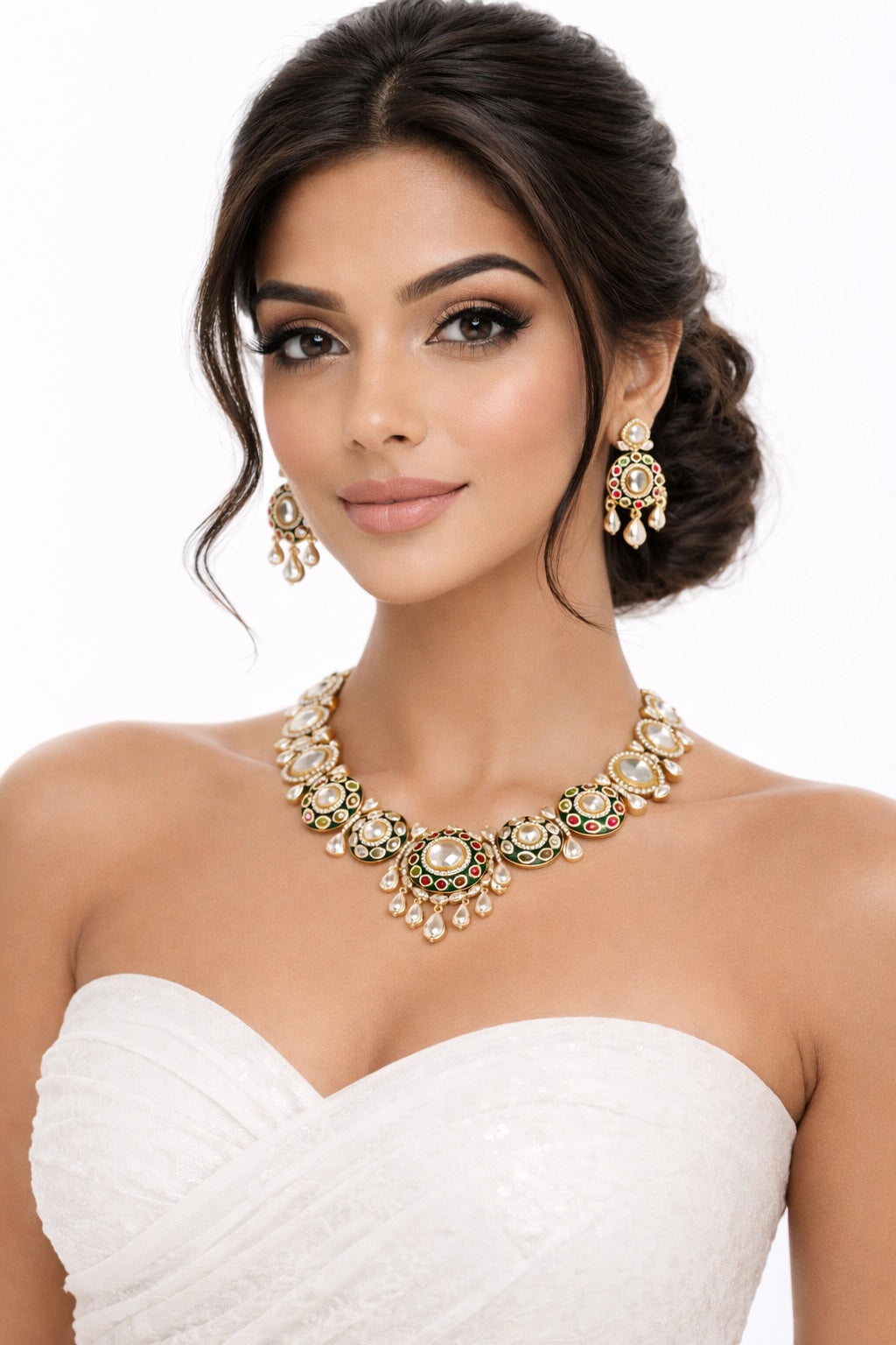 Woman wearing a gold necklace and earrings on a white background