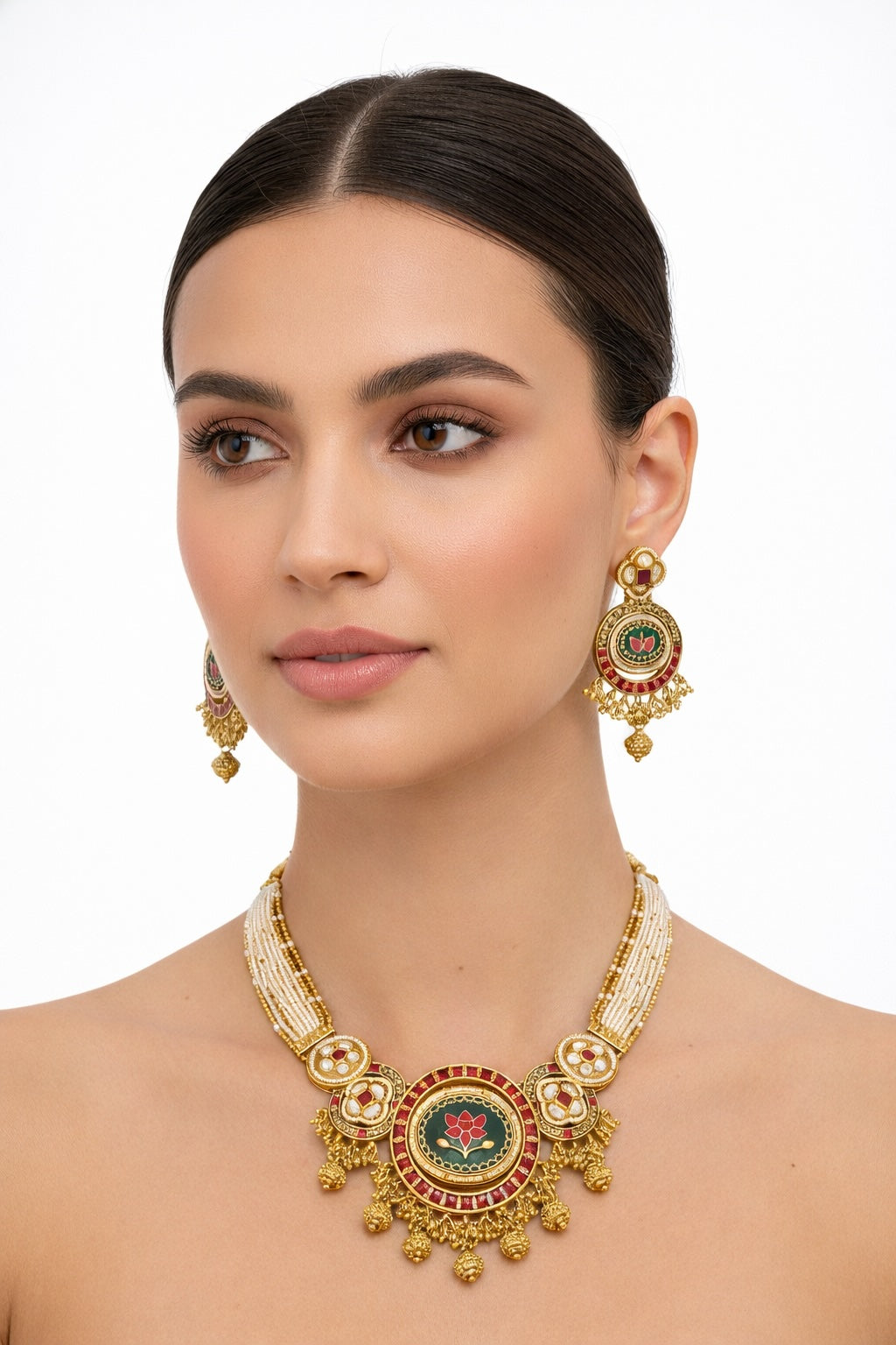 Woman wearing a gold necklace and earrings with a white background