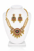 Gold necklace and earrings set on a white mannequin bust