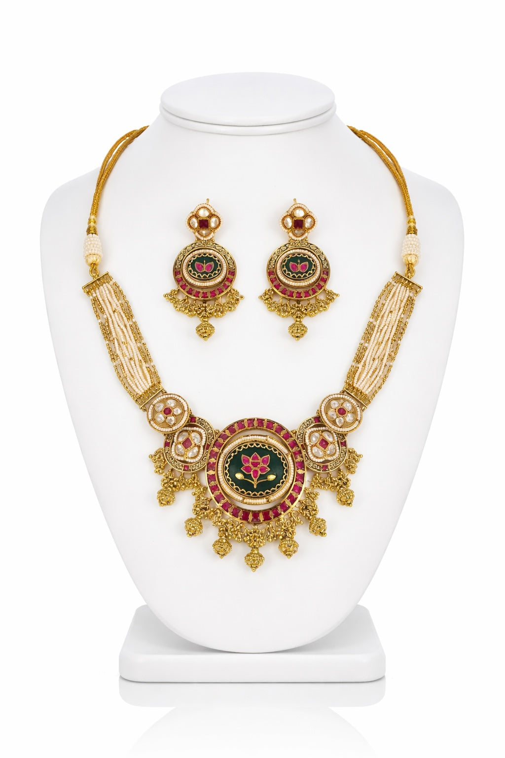 Gold necklace and earrings set on a white mannequin bust