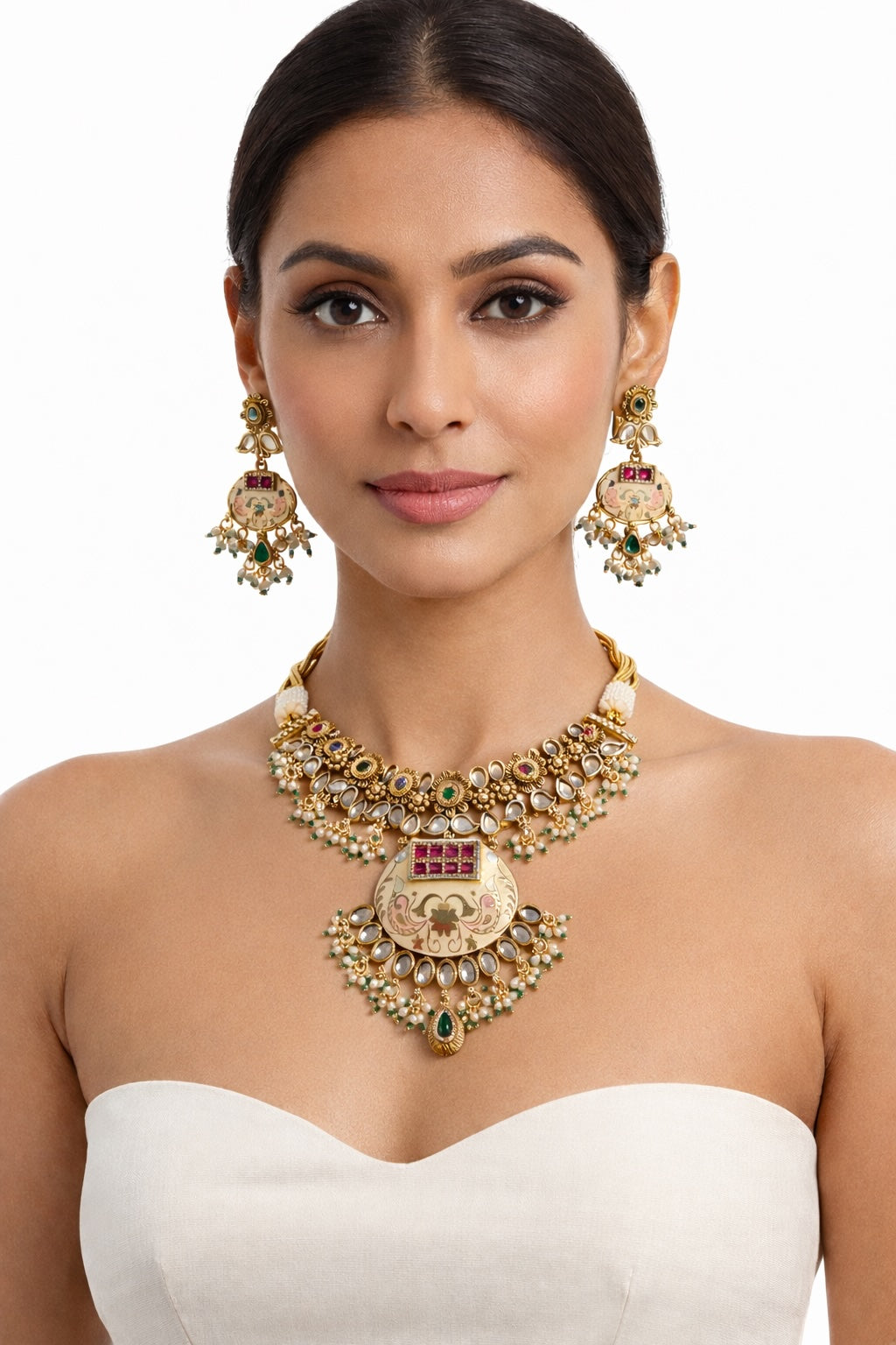 Woman wearing a gold necklace and earrings on a white background