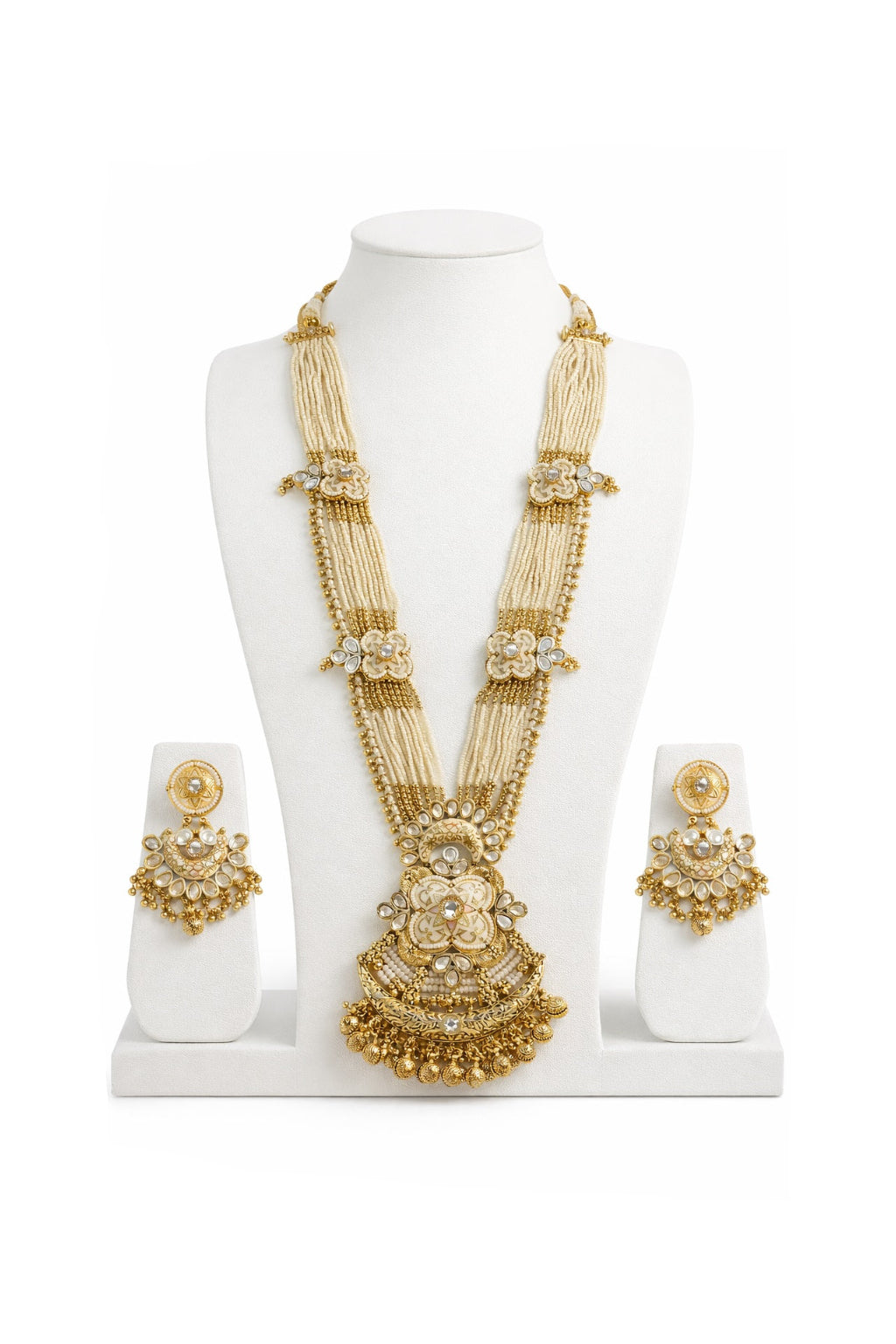 Gold necklace and earrings set on a white mannequin