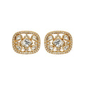 Pair of gold earrings with diamond-like stones on a white background