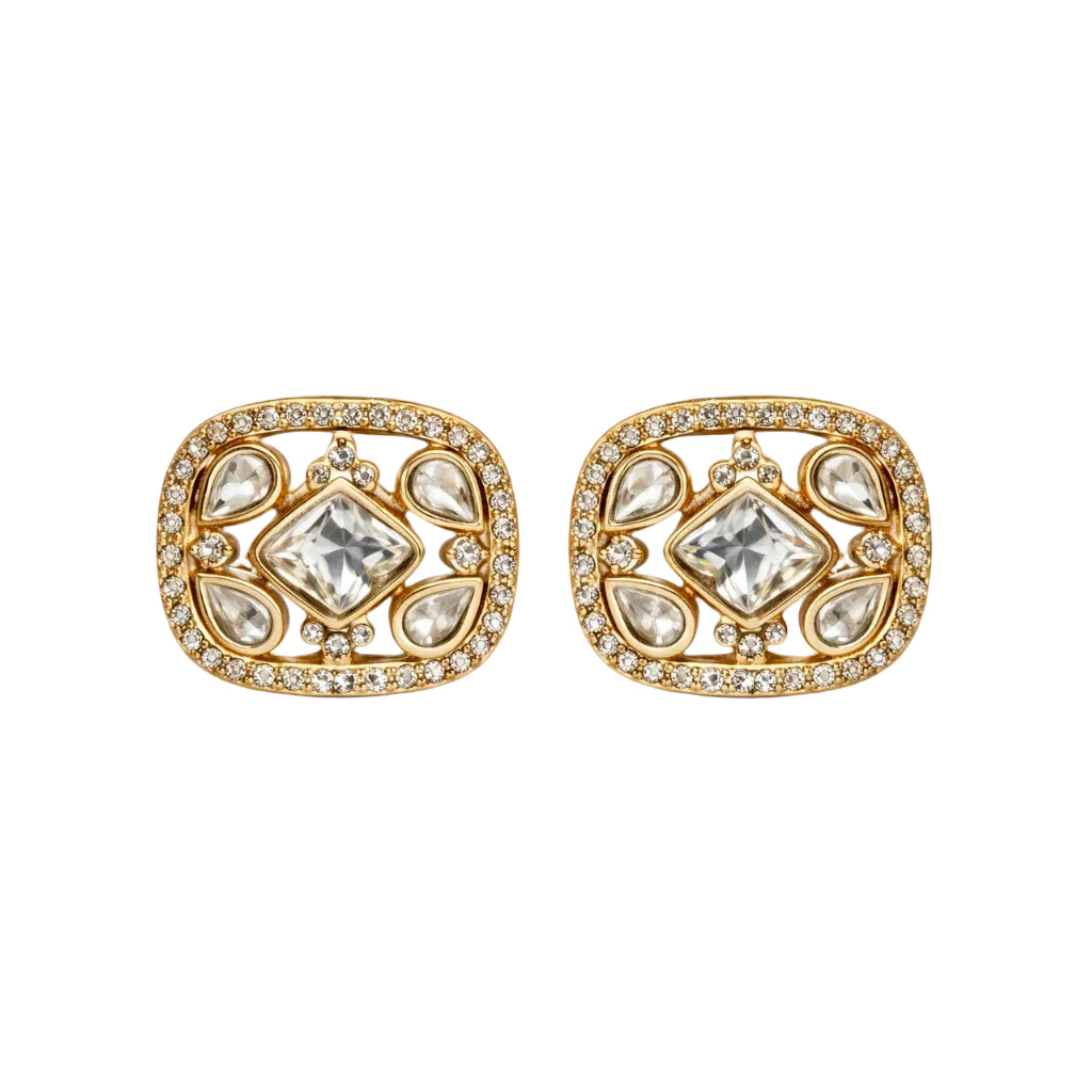 Pair of gold earrings with diamond-like stones on a white background